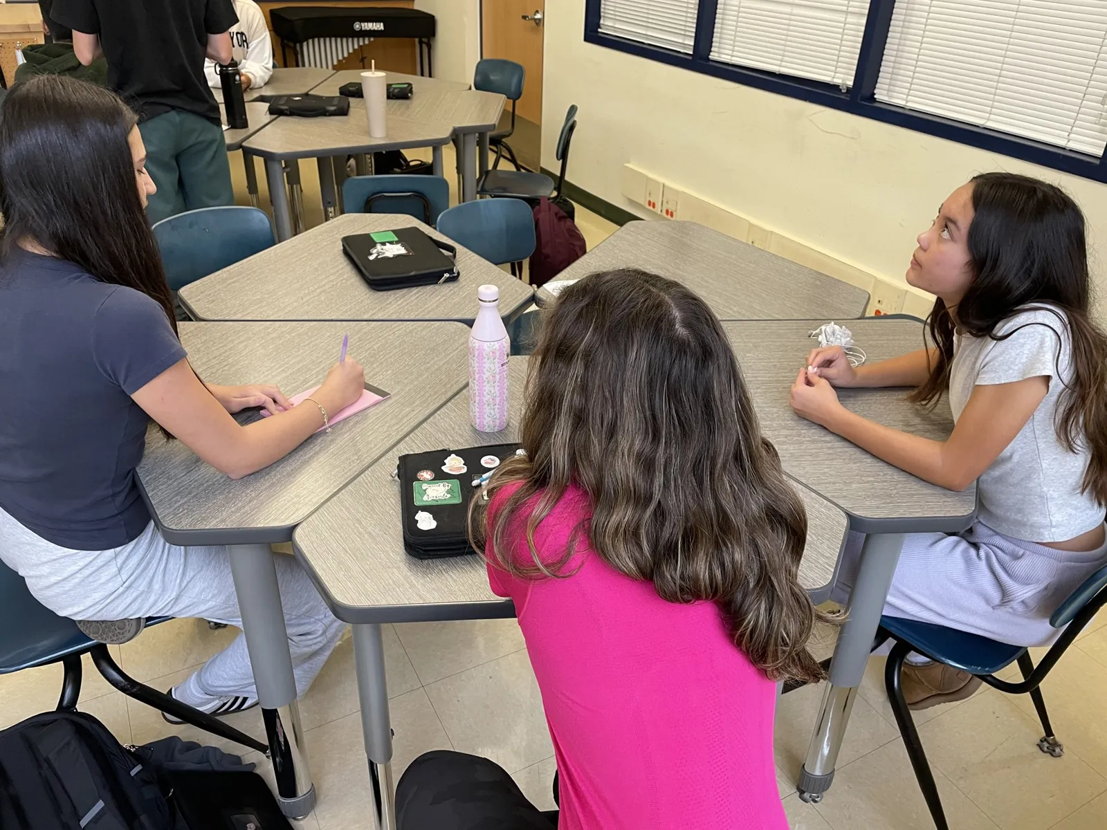 Students discussing a money decision