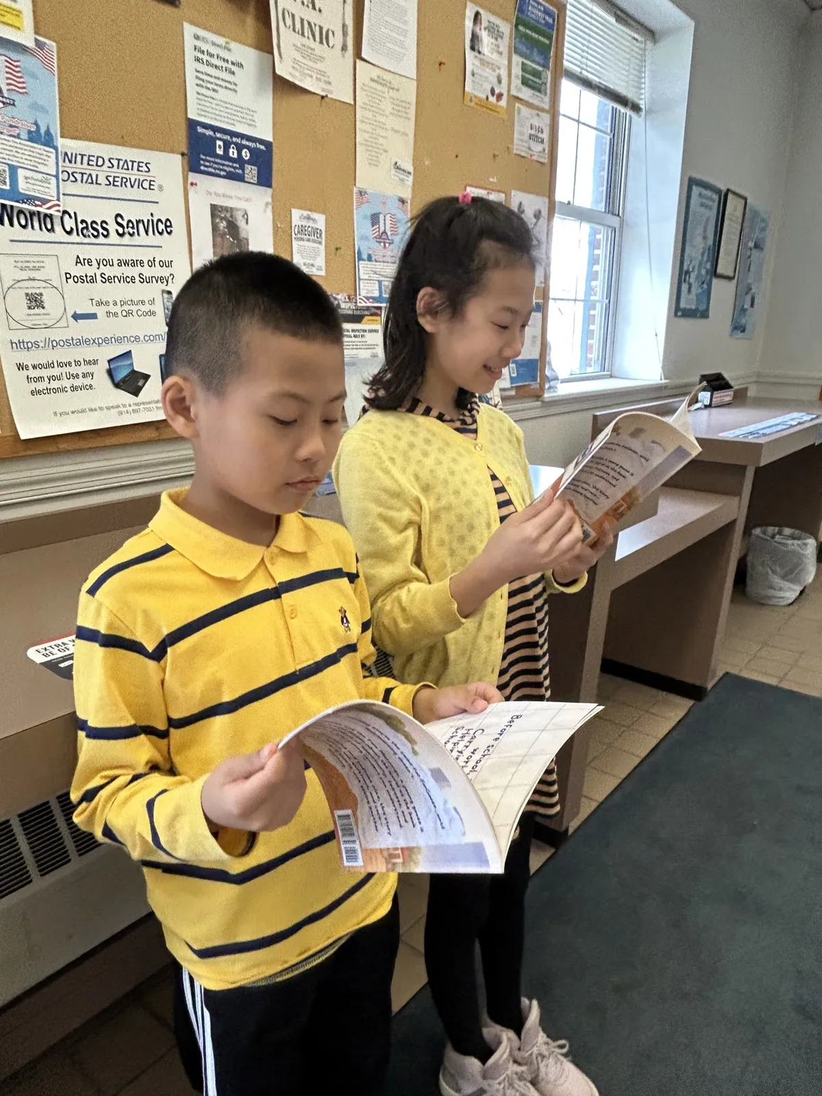 Two kids reading FinGoose books together